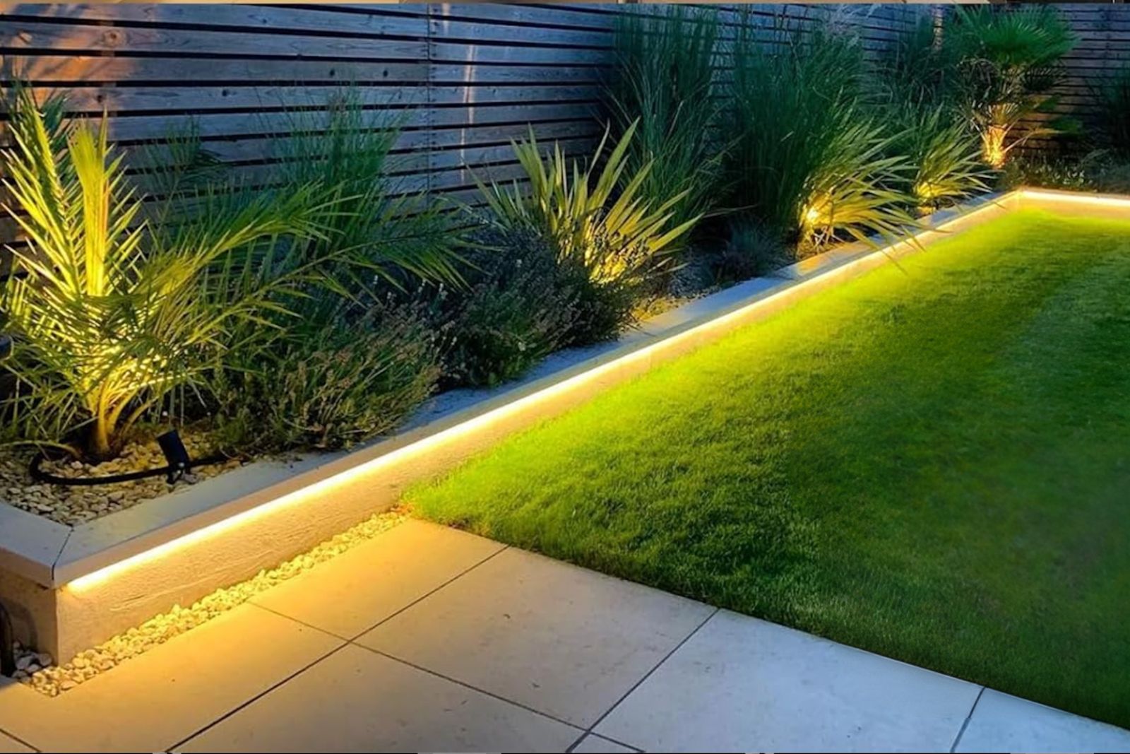 Landscape lighting along a lawn edge